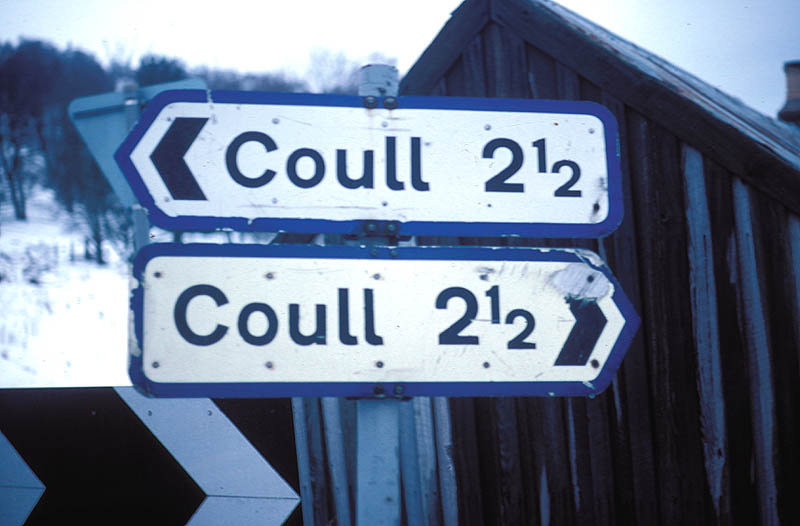 two signs that both say Coull 2 1/2 pointing in opposite directions